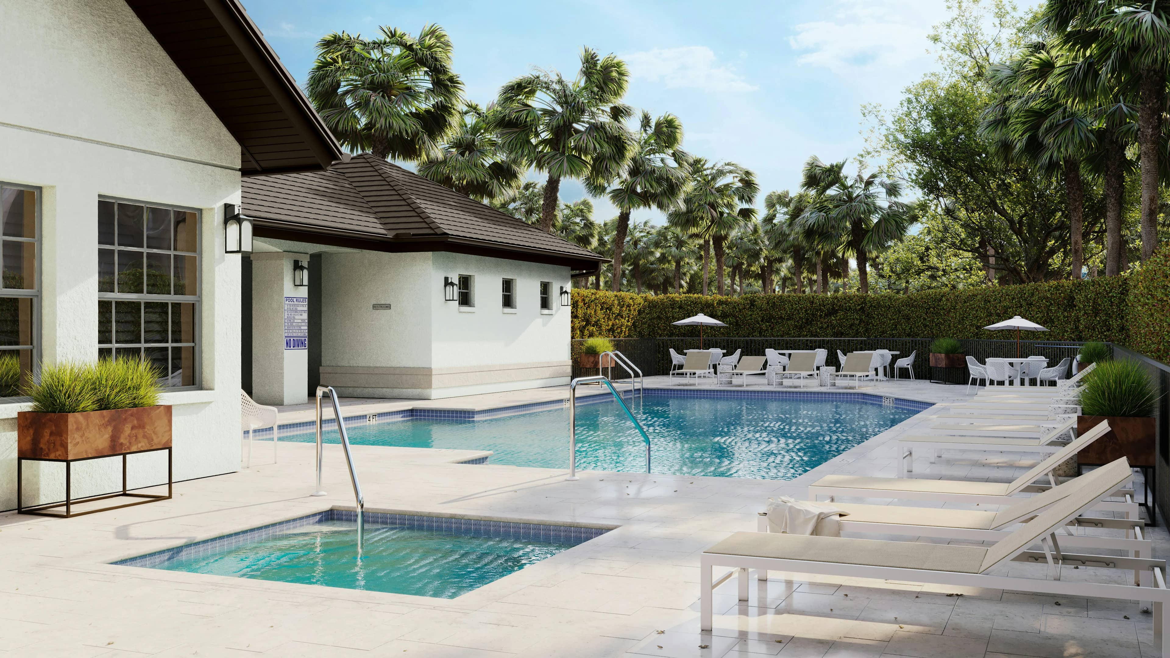 Landscaped pool and spa beside a white home